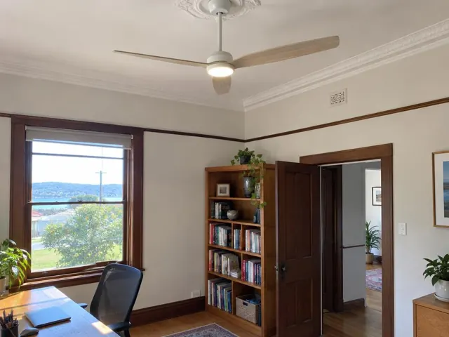 Ceiling fan on a decorative ceiling in a timber-trimmed living room in Woy Woy